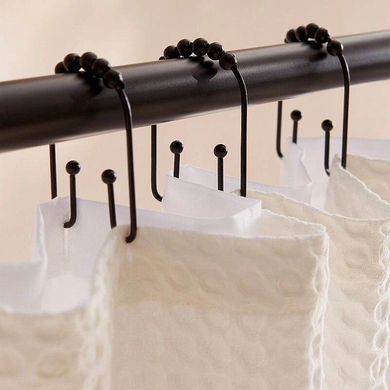 Decorative curtain hooks attached to stylish curtains