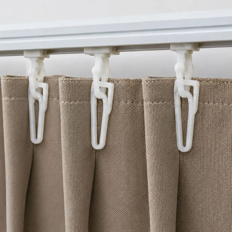 Plastic curtain hooks attached to curtain header
